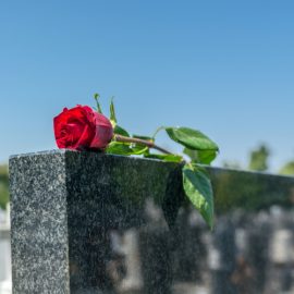 Gravestone with withered rose